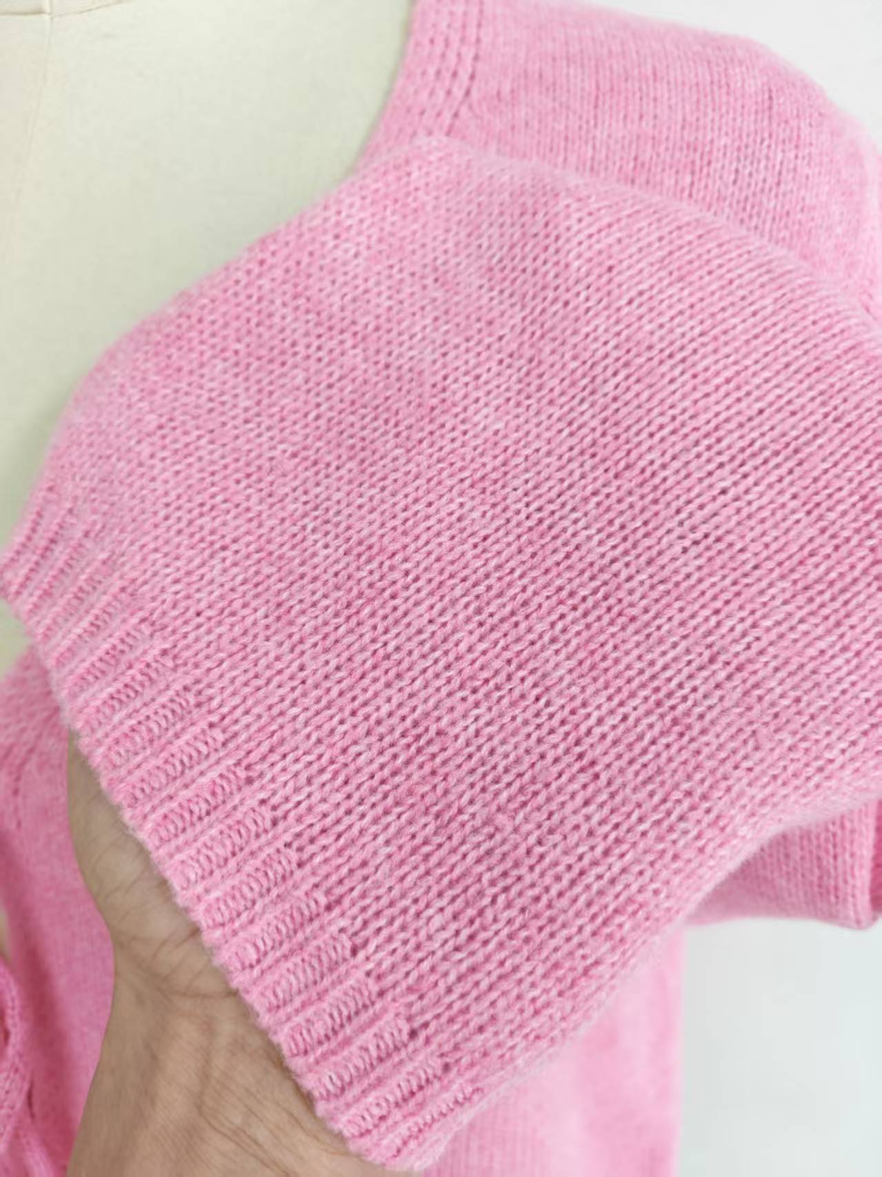 Close-up fabric texture of pink knit cardigan sweater TF8842