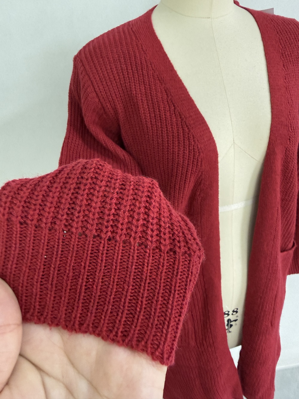 Close-up neckline and knit texture of burgundy cardigan TF8765