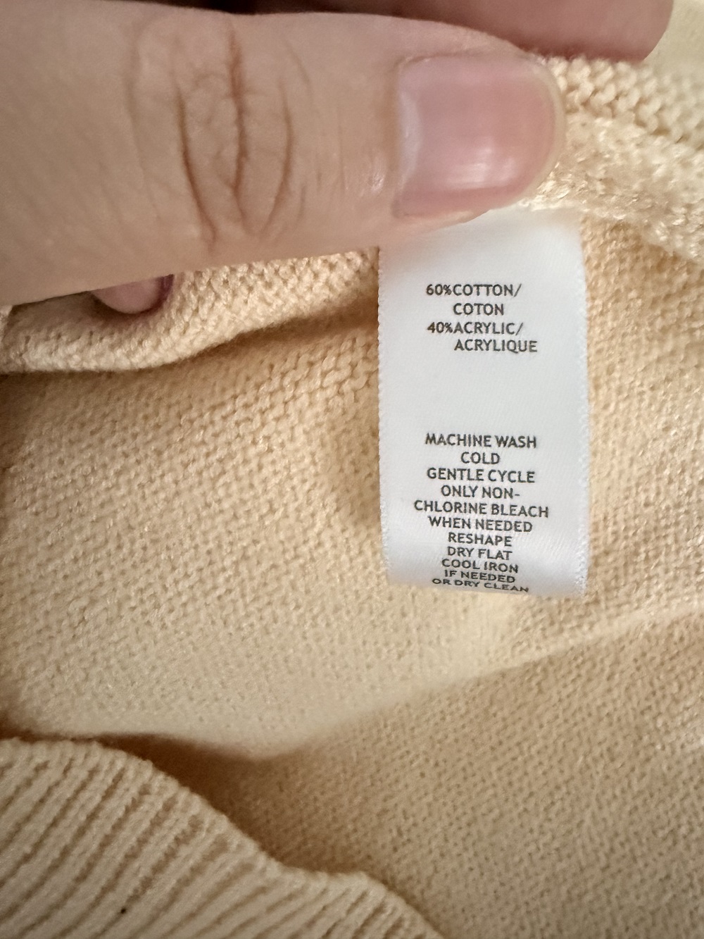 Care label and fabric detail of women's knit cardigan TF8669