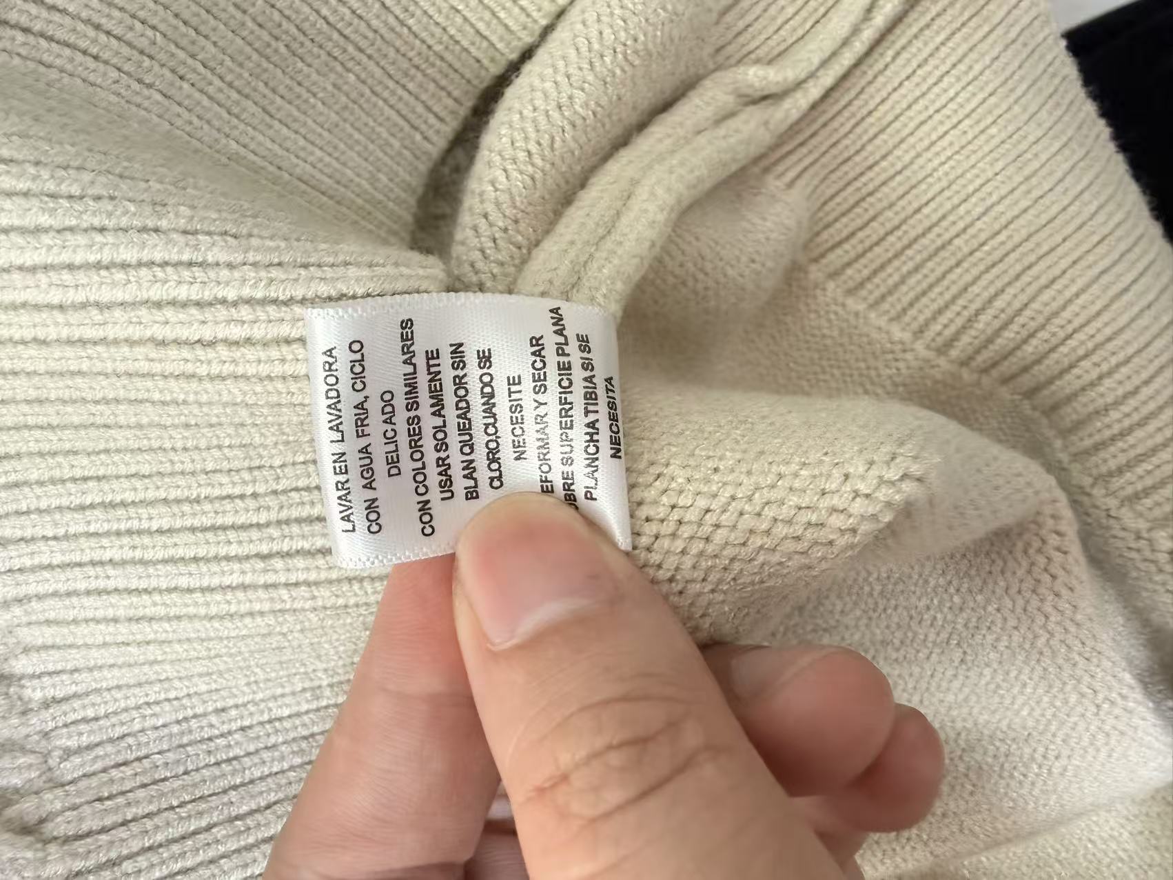 Care label and neckline detail of women's knit sweater TF8598