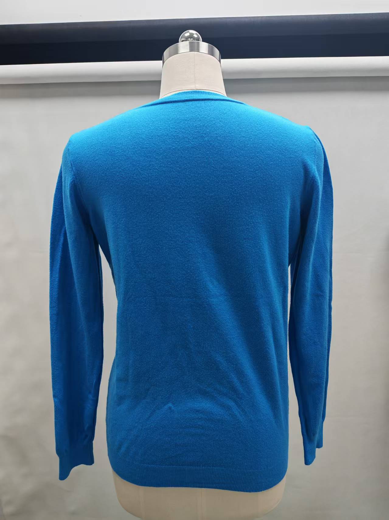 Back view of women's blue knit sweater TF8639
