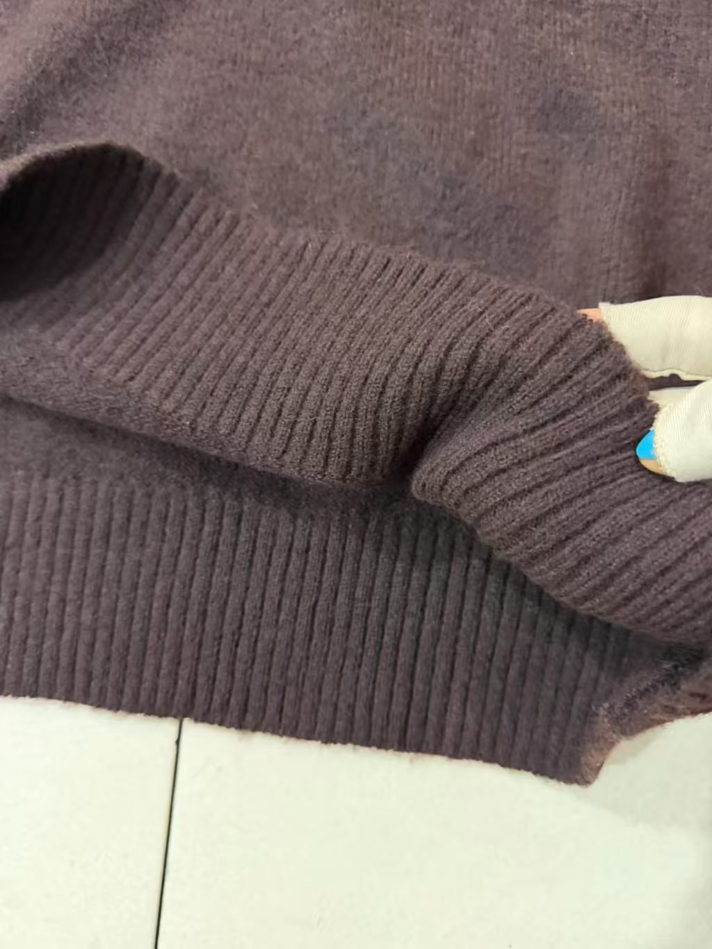 Sleeve and knit texture detail of brown sweater TF8687
