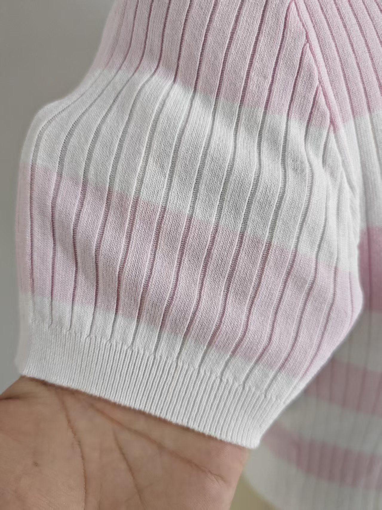 Detail shot ribbed cuff of women striped short sleeve knit sweater TF9026