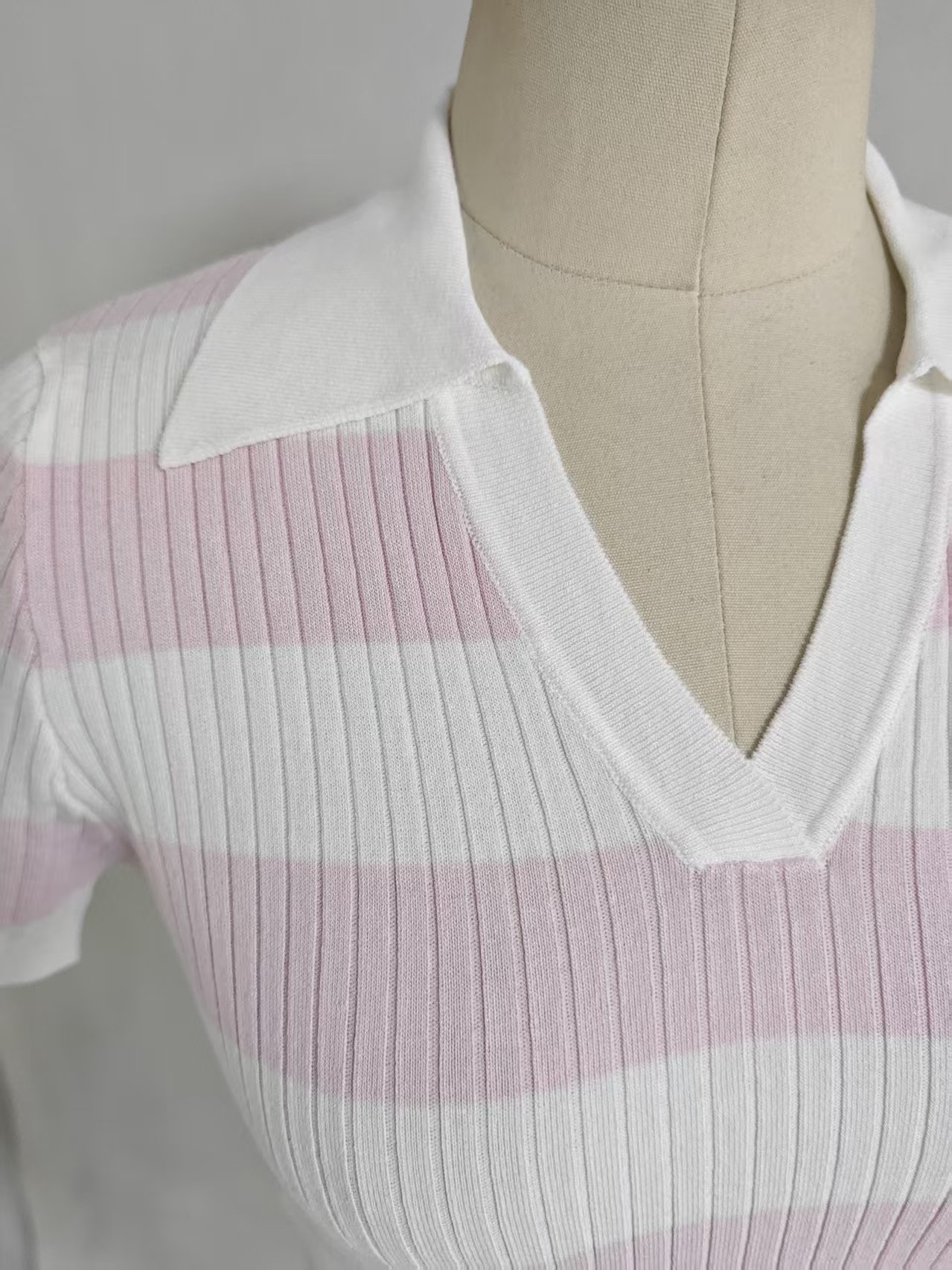 Close up front view ladies pink white striped V neck knit shirt TF9026