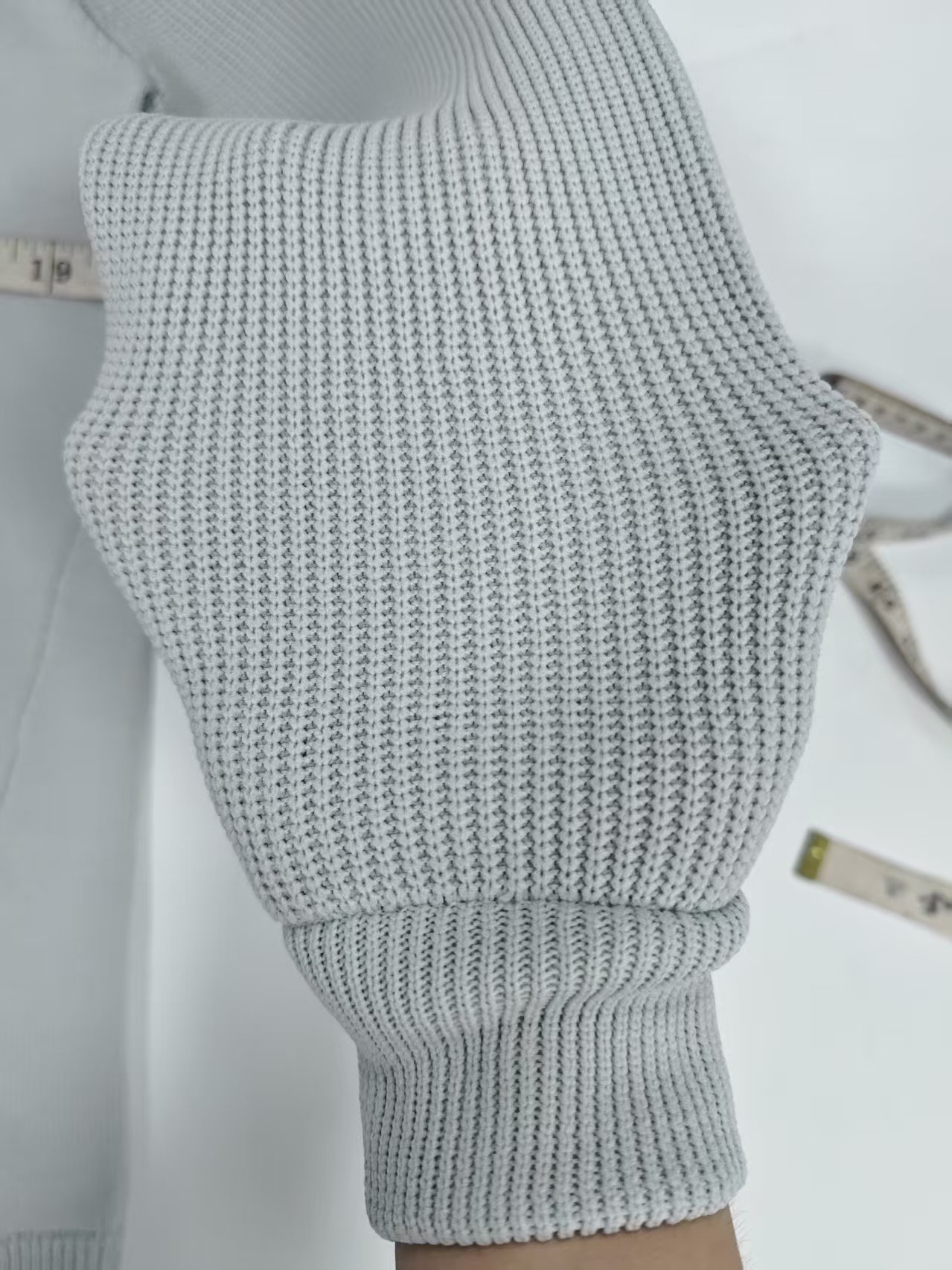 Close up ribbed sleeve cuff detail of men grey knit sweater TF8830