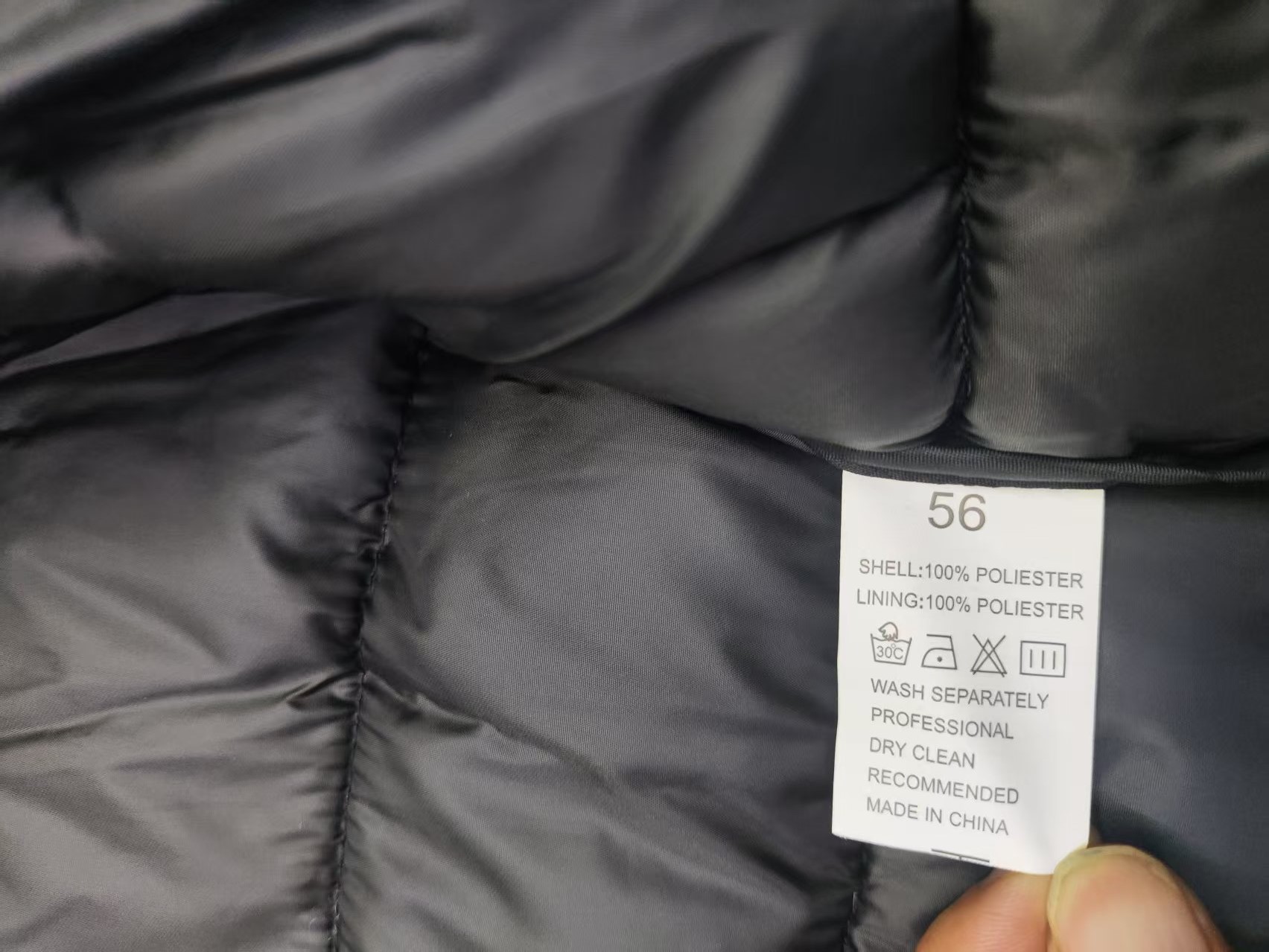 Men's puffer jacket fabric and care label detail TF8928 close-up