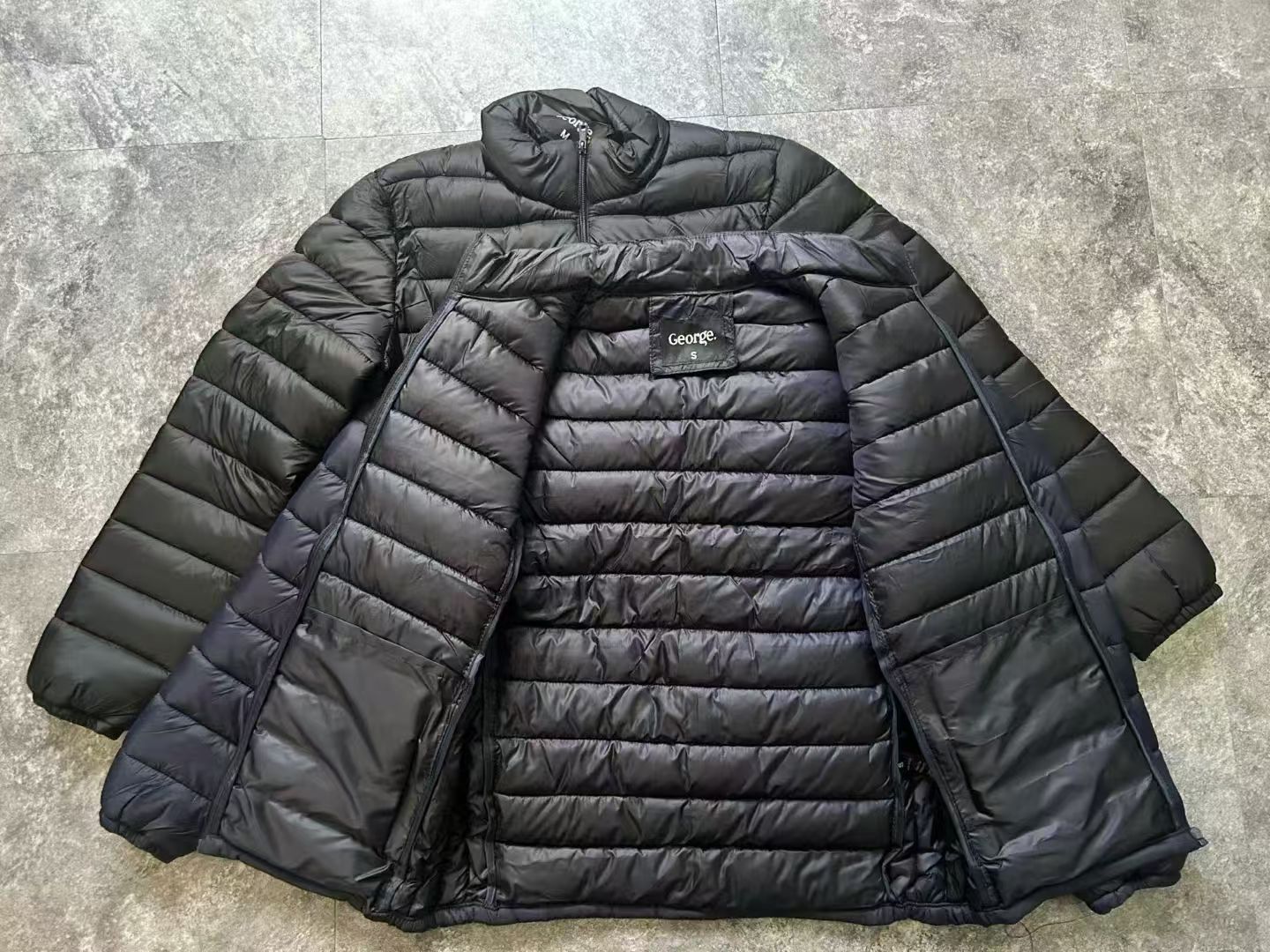Front view of men's black 100 percent polyester puffer jacket TF9000