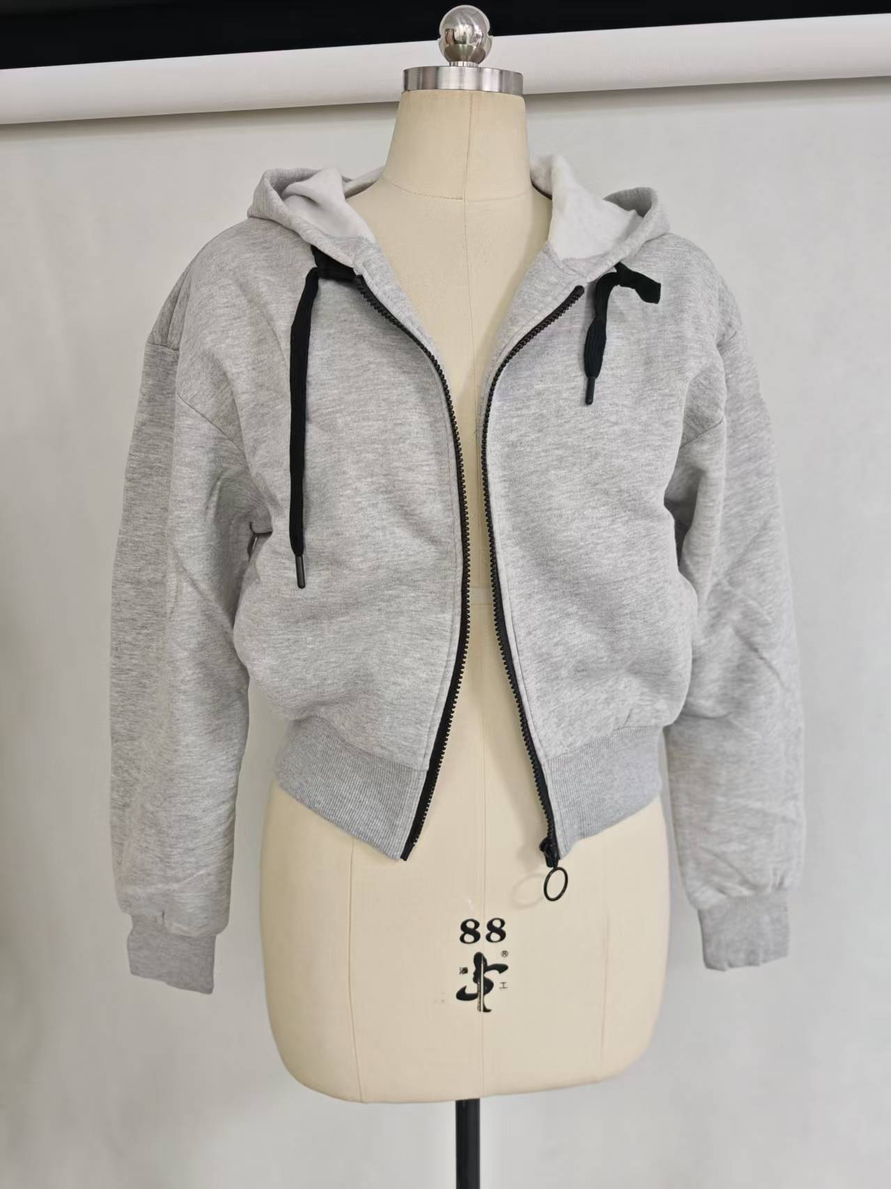 Wholesale ladies heather grey zip up cropped hoodie TF8854 on mannequin front view, 60% cotton 40% polyester