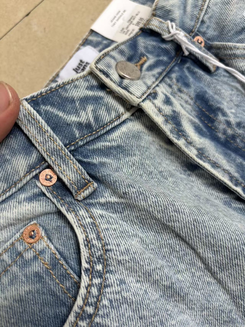 Front waistband and button detail on ladies sky blue jeans TF8697