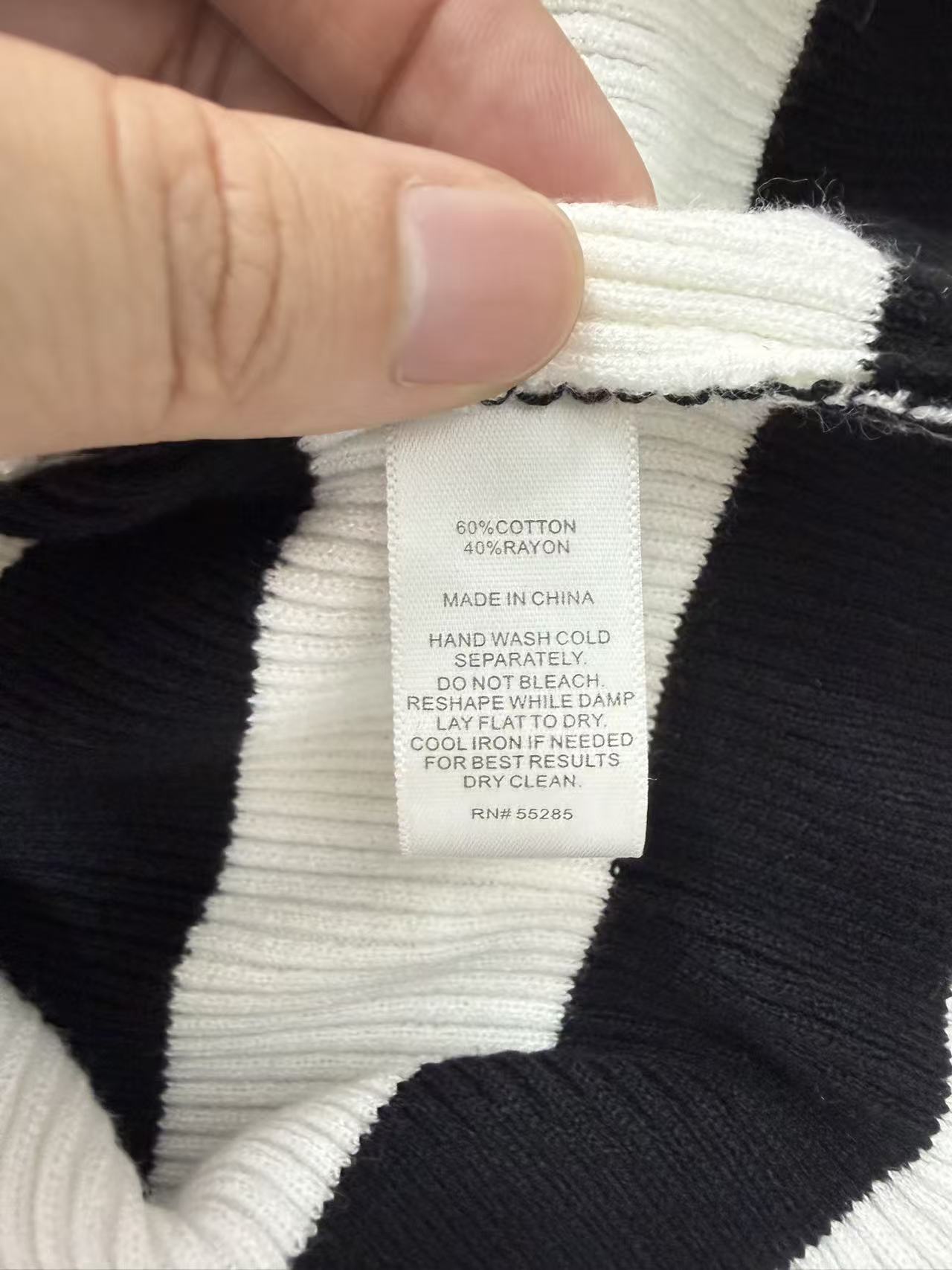 Care label close-up ladies black white stripe knit sweater TF8959