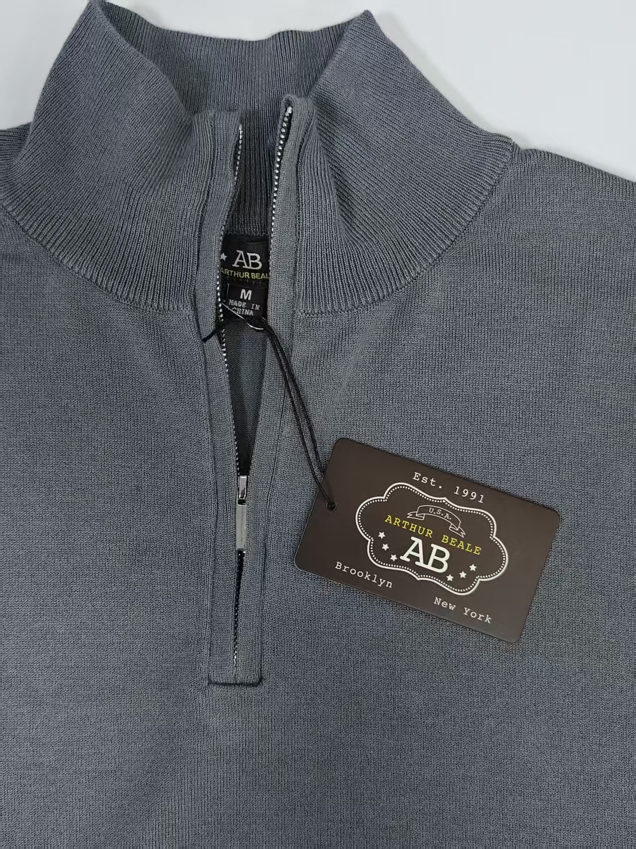 Close up of zipper and collar on men's pullover sweater TF7822