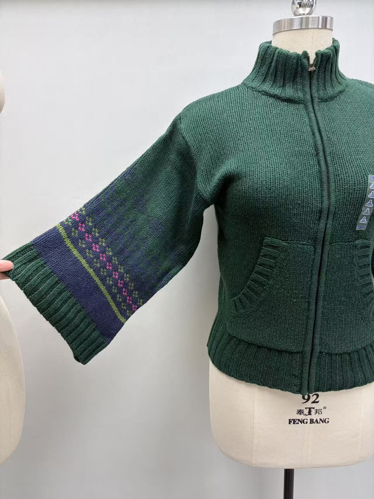 Front view of women's green v-neck knit cardigan sweater