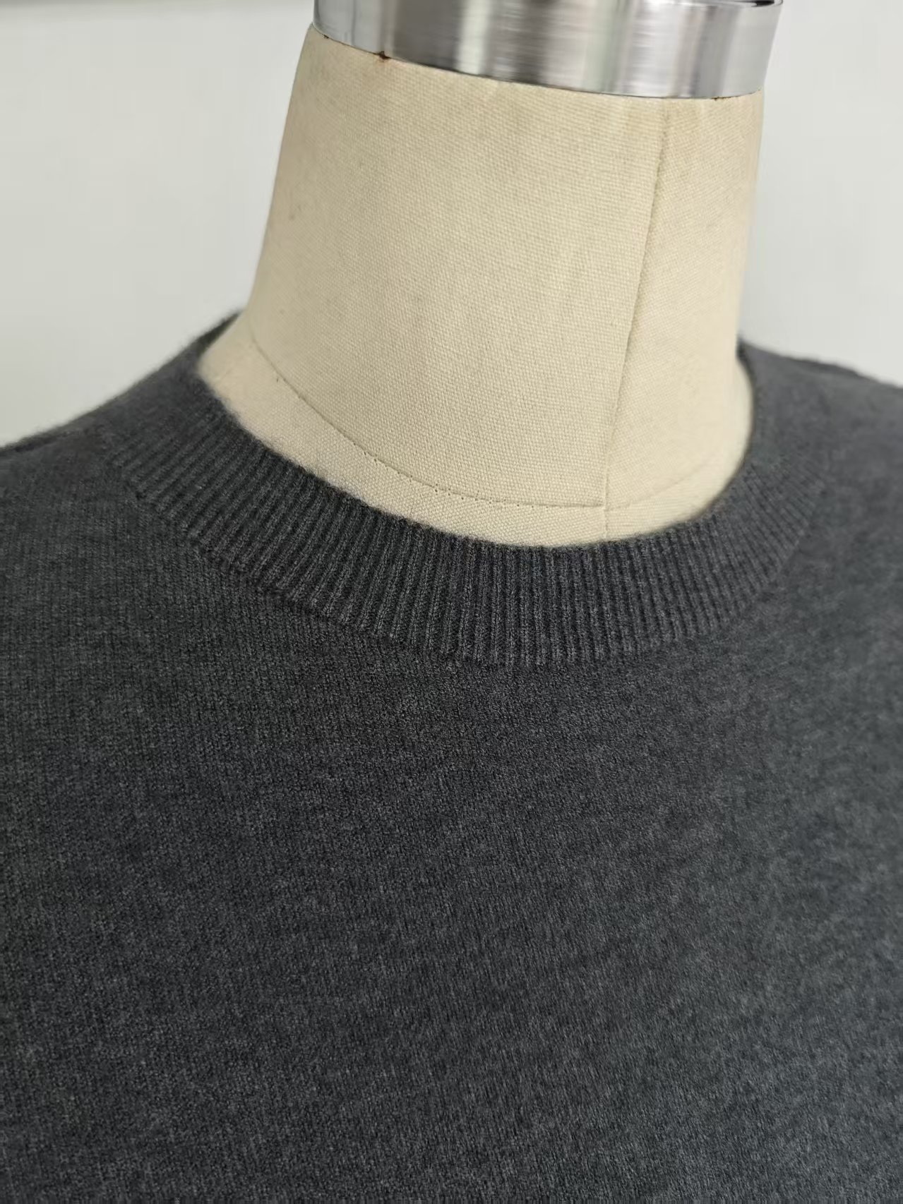 Mannequin display of dark grey ladies' crew neck sweater