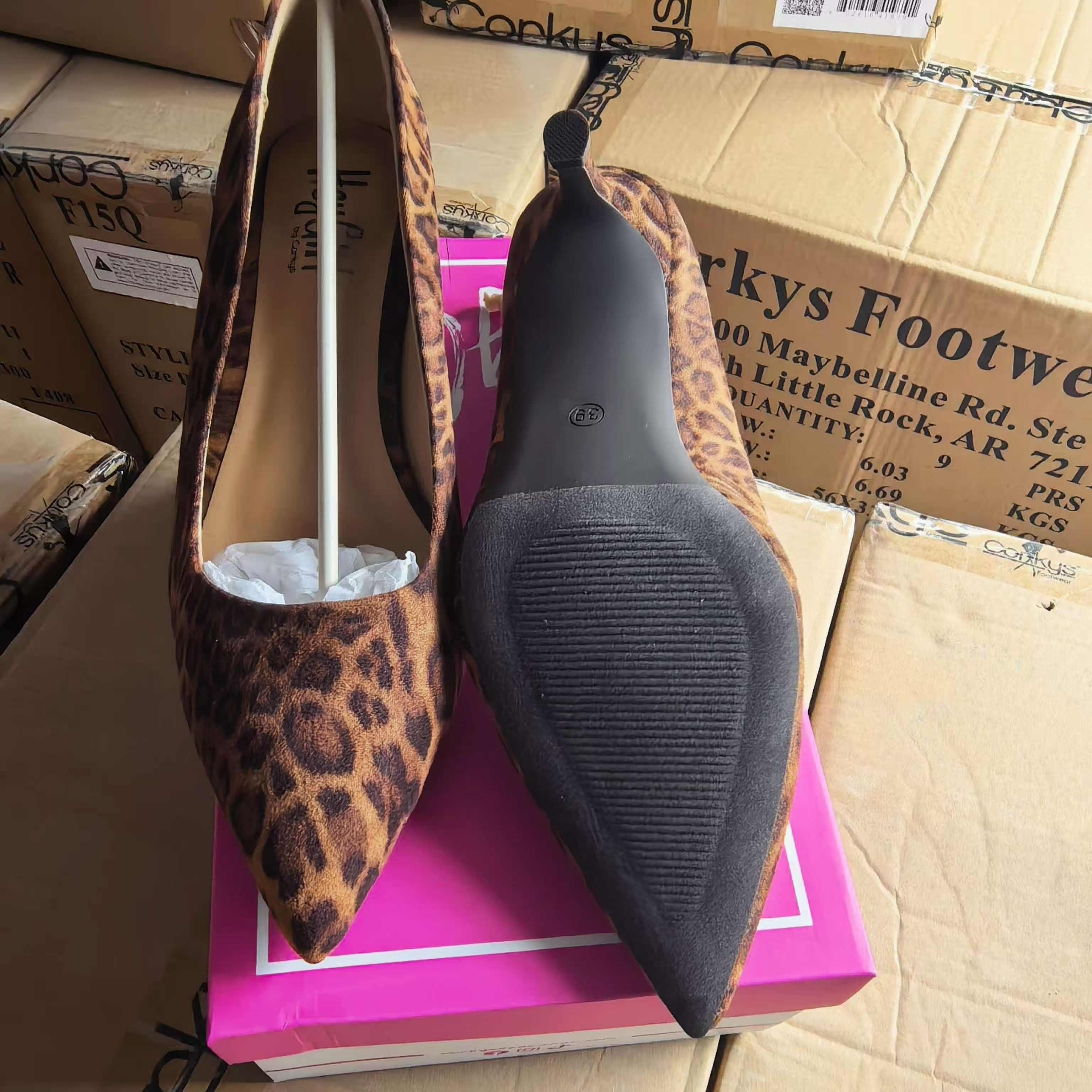 Bulk packaged women's flat sandals on display with shoe boxes