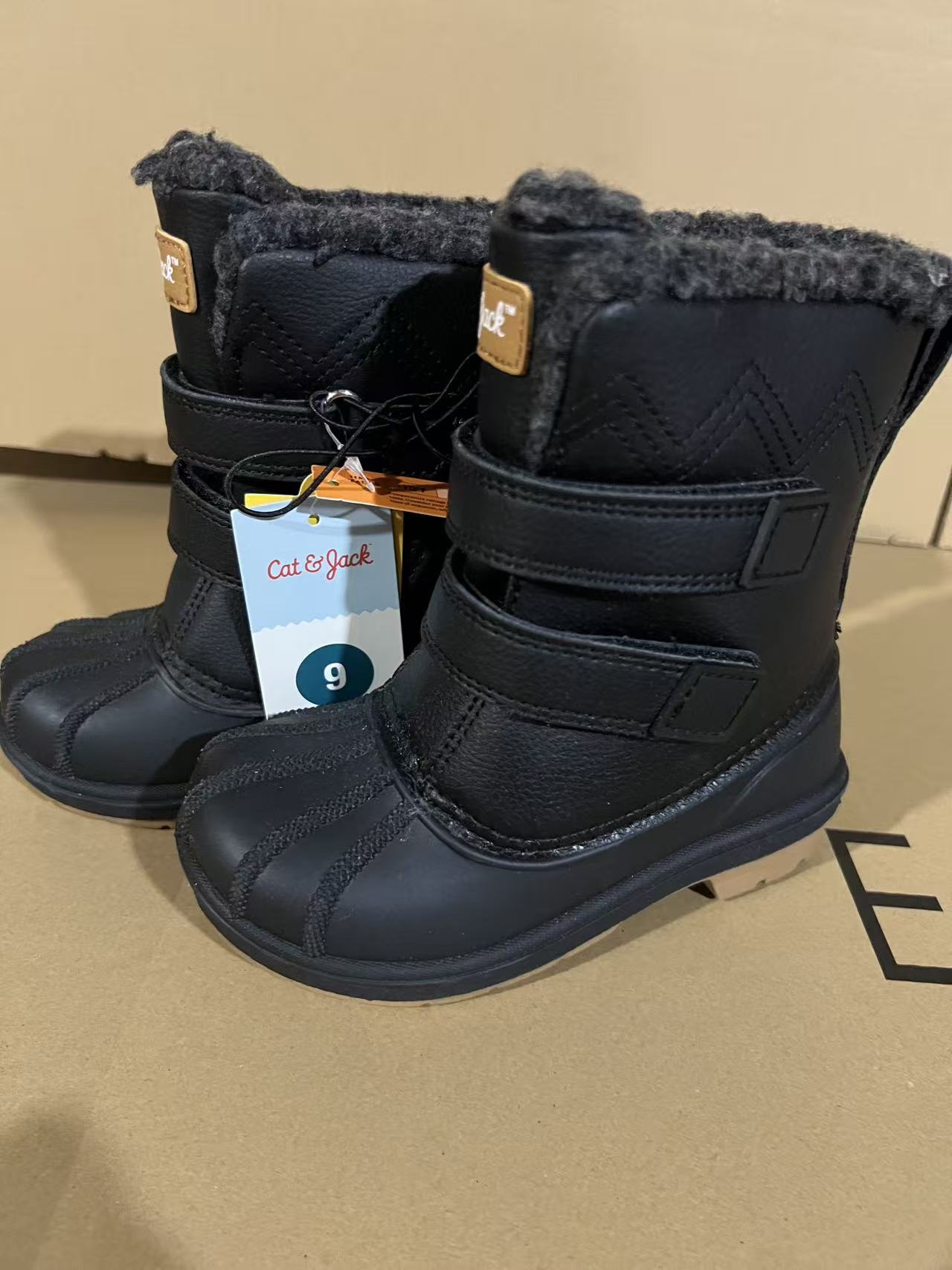 Pair of classic black plush-lined kids snow boots