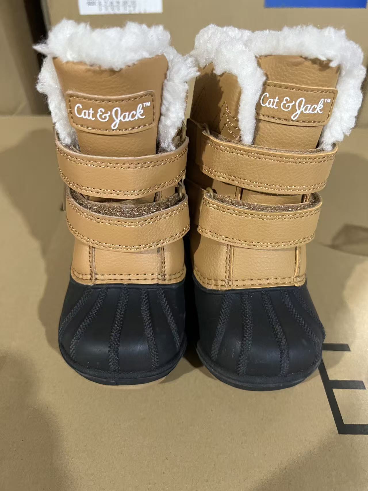 Pair of brown suede kids winter boots with fleece lining