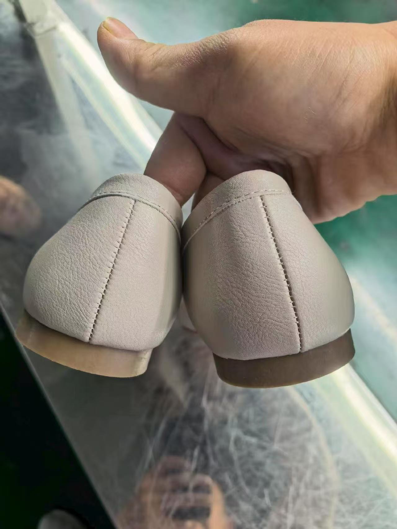 Heel view of ladies' off-white low heel flat shoes