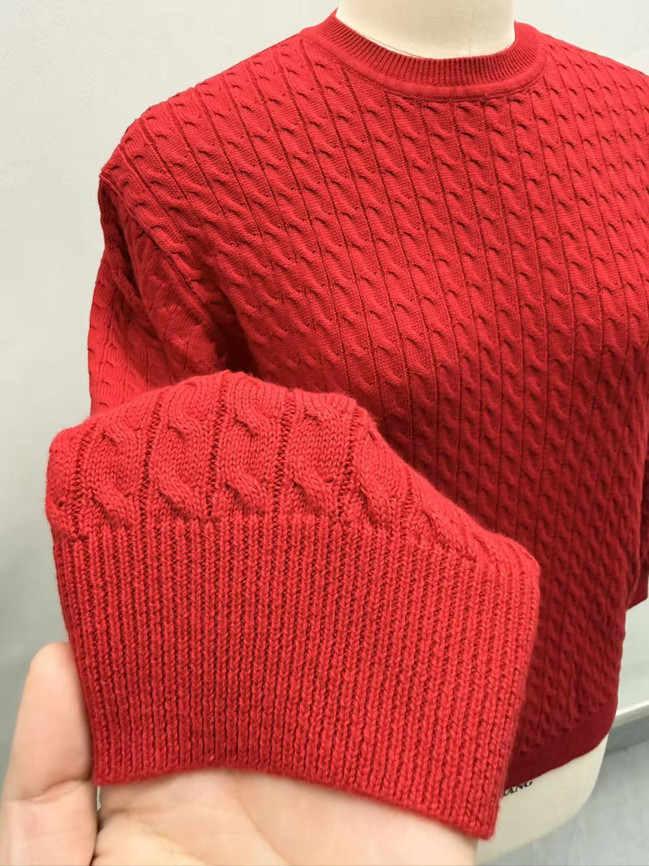 Close-up detail of red cotton knit fabric and crew neck collar