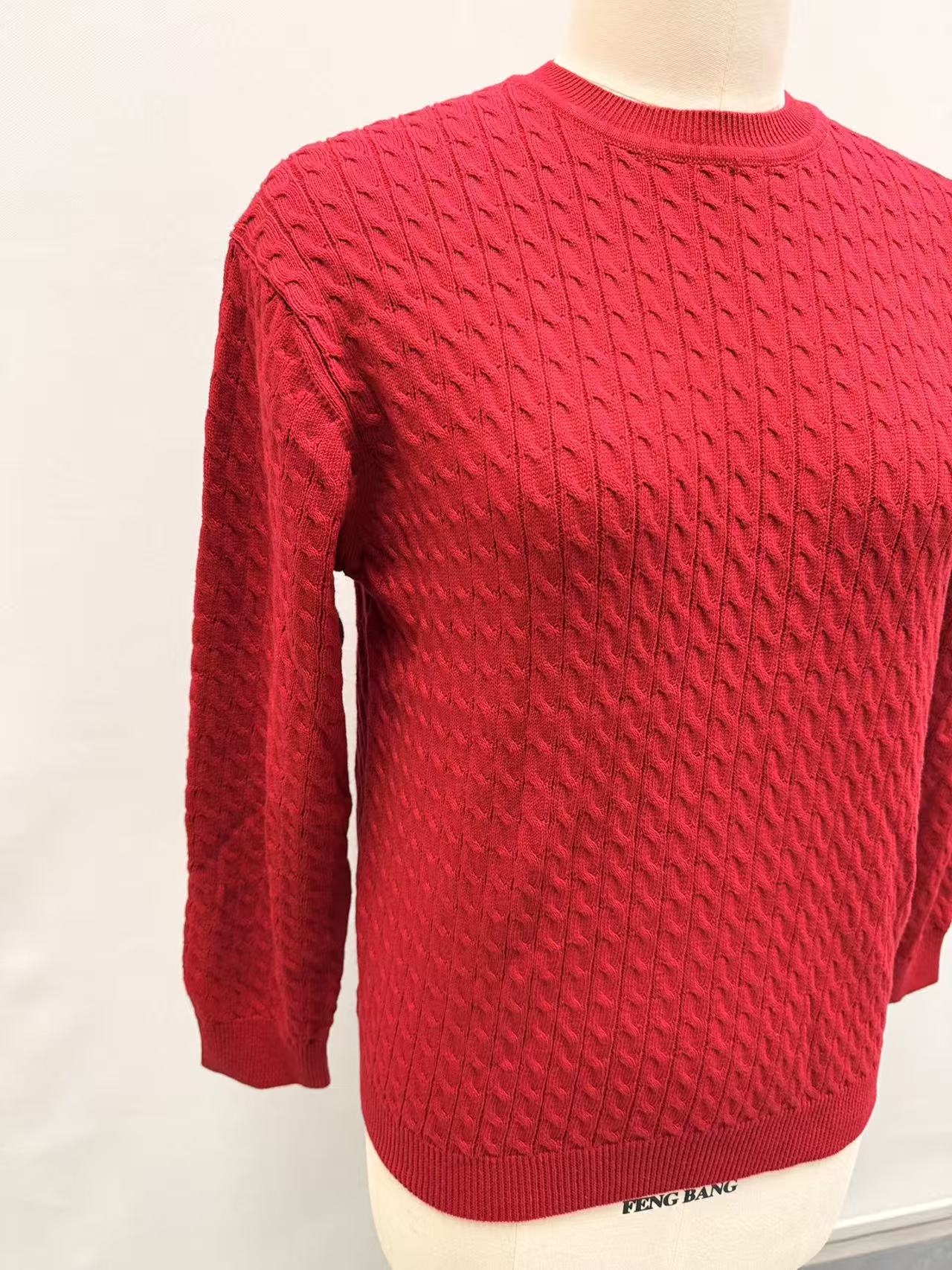 Side view of women's red long sleeve knit pullover sweater
