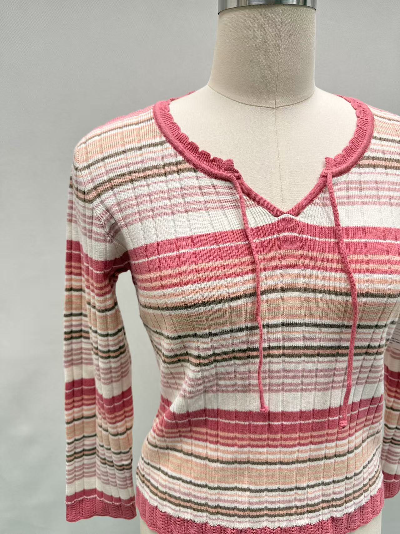 Front view of women's red striped crew neck knit pullover sweater