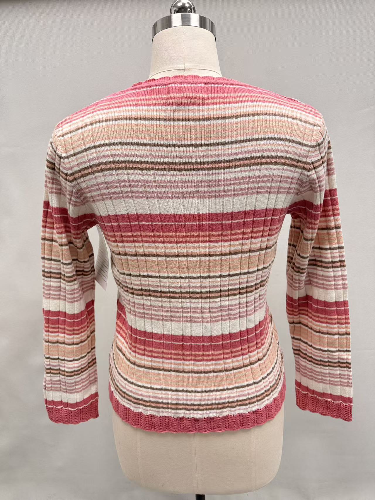 Back view of women's red and white striped long sleeve sweater