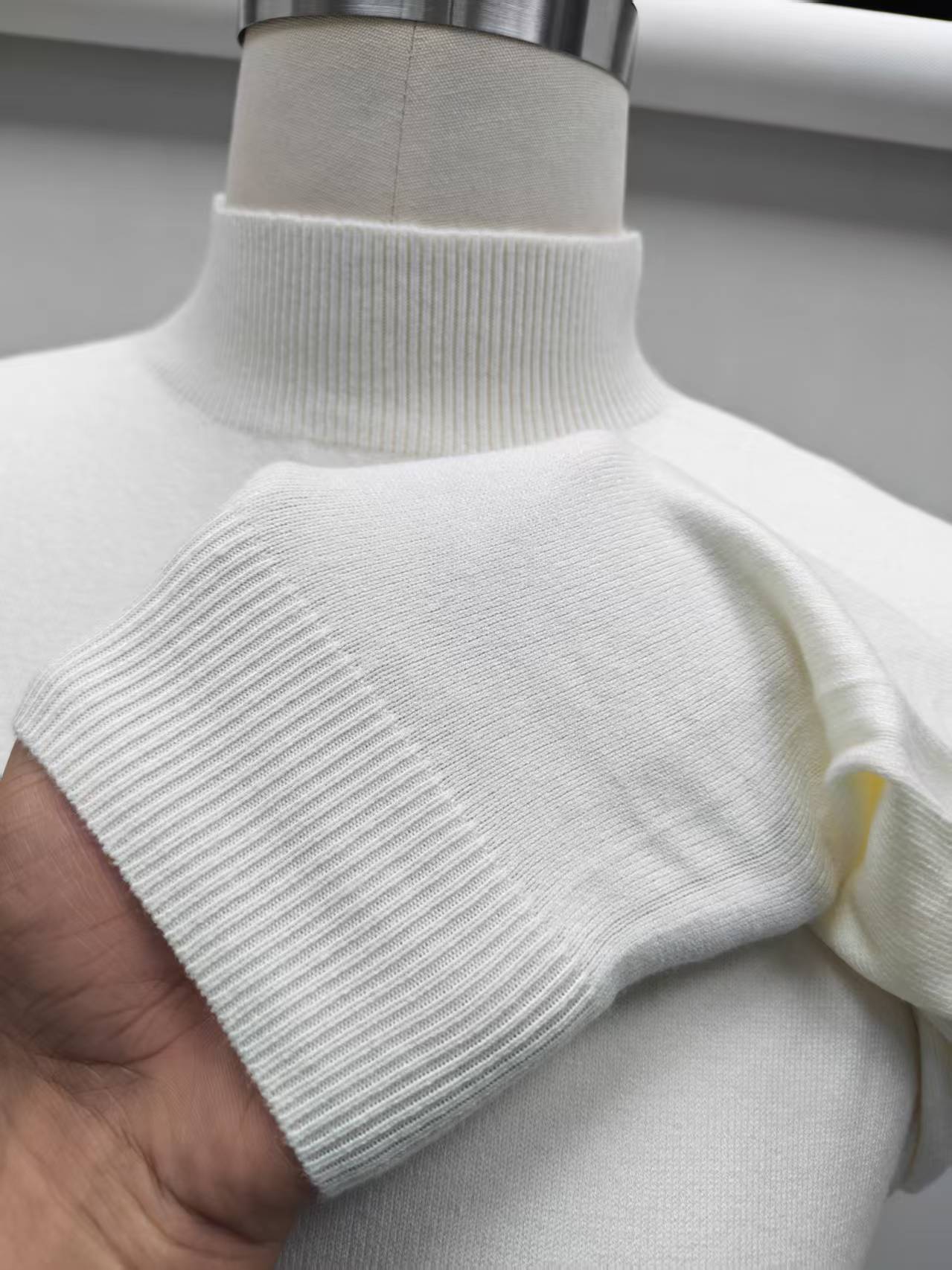Close-up detail of high collar and soft cotton knit fabric