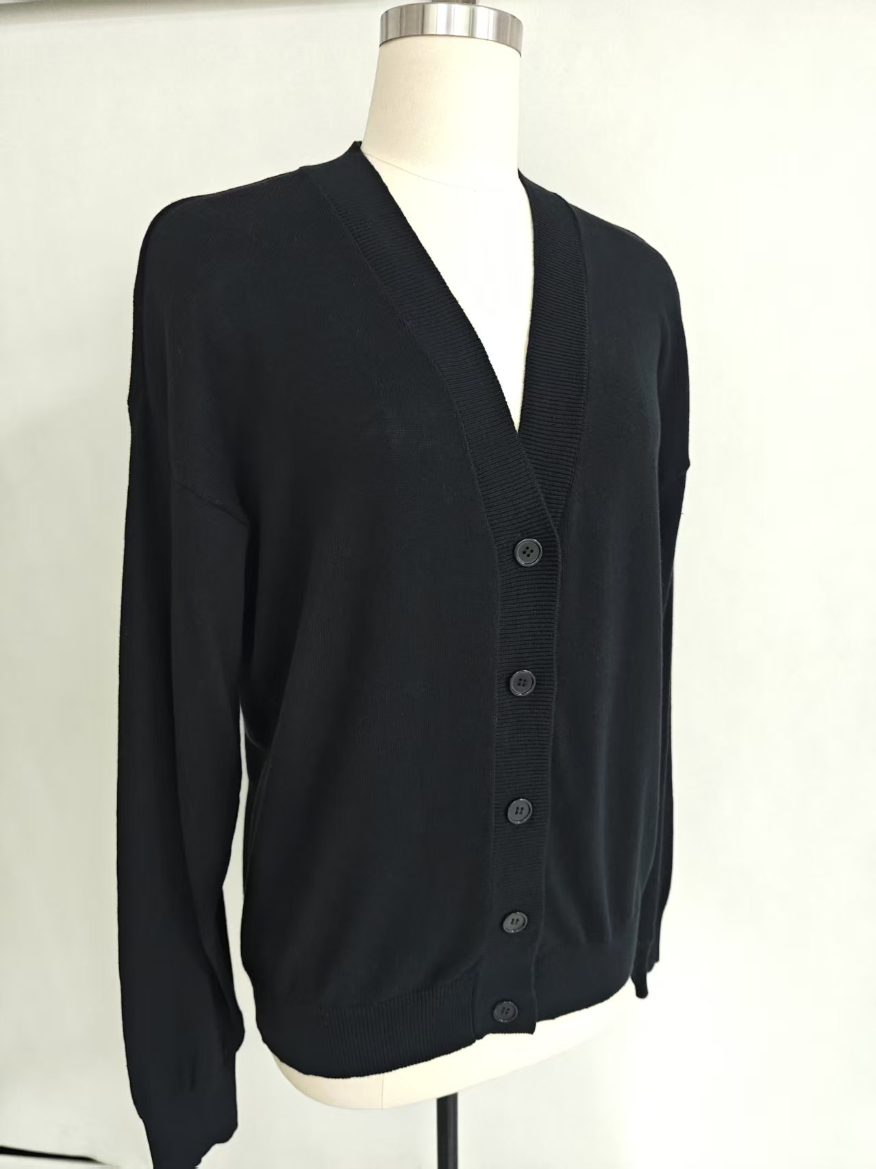 Front view of women's black long sleeve knit cardigan sweater