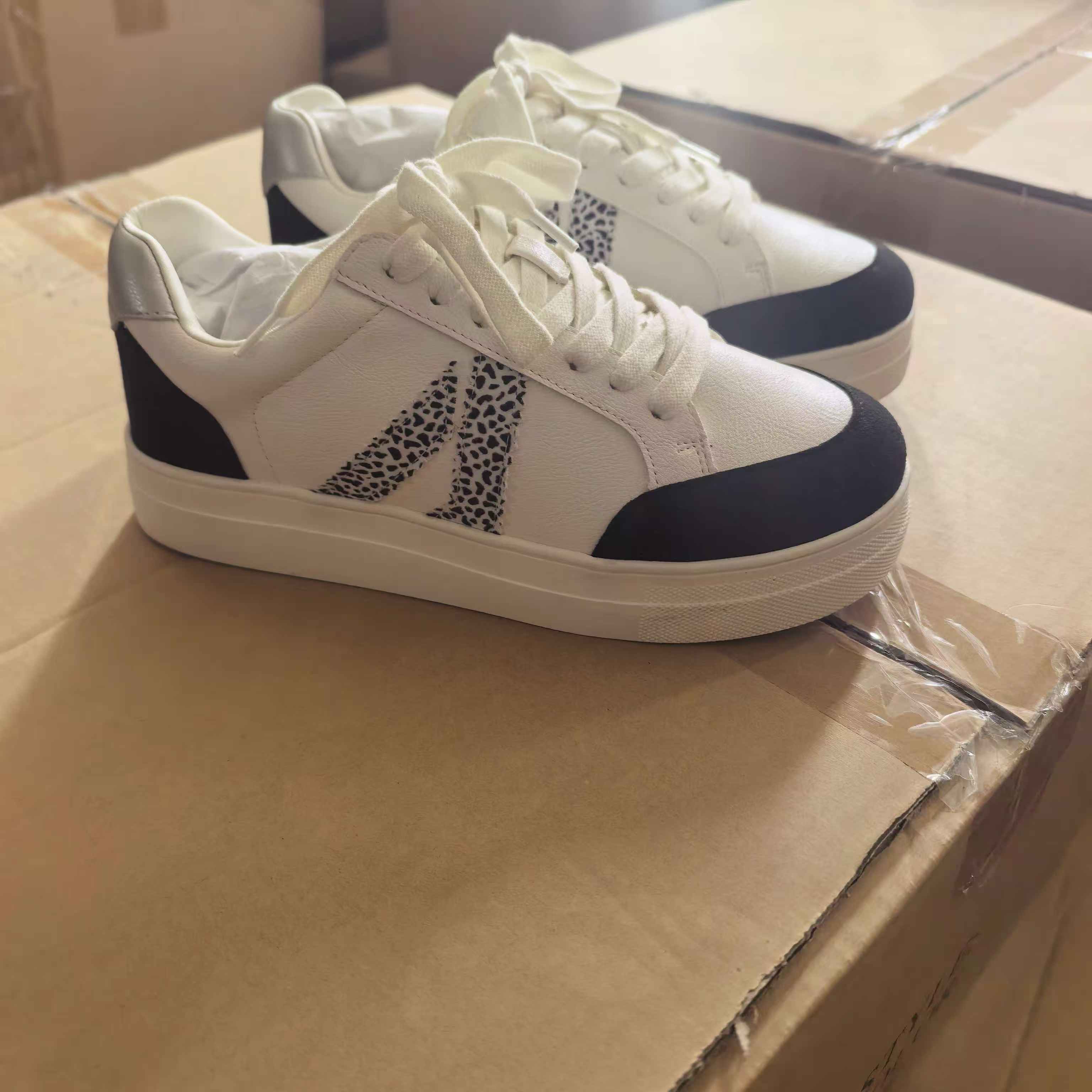 Side view of women's white and blue leather casual sneakers