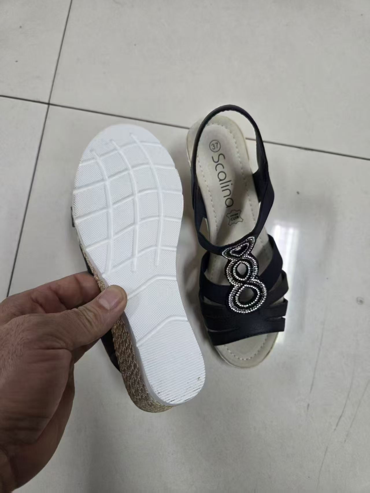 Side view of women's blue sandals with white rubber outsole
