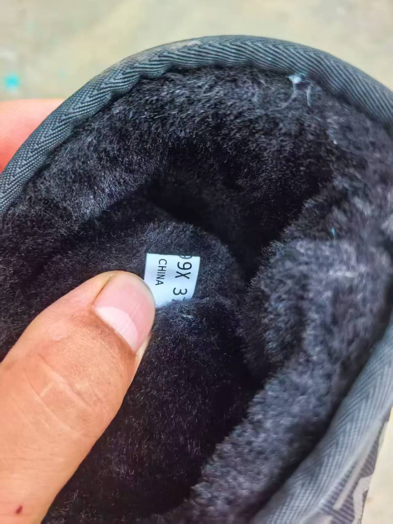 Close-up of soft plush lining inside women's black boots