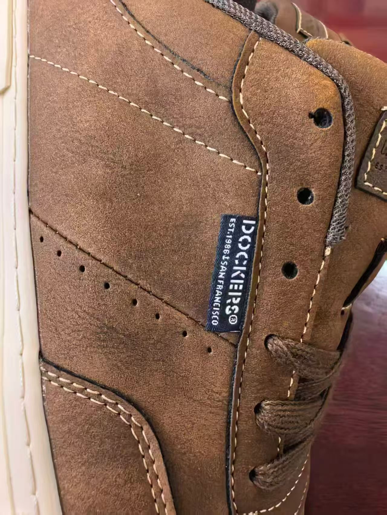 Close-up detail of brown leather texture and laces TF9516