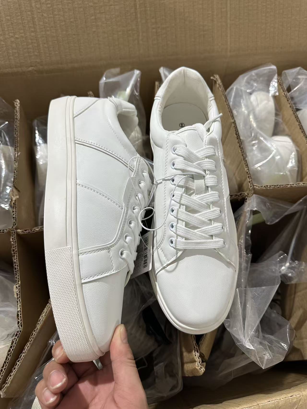Side view of men's white casual sneakers wholesale