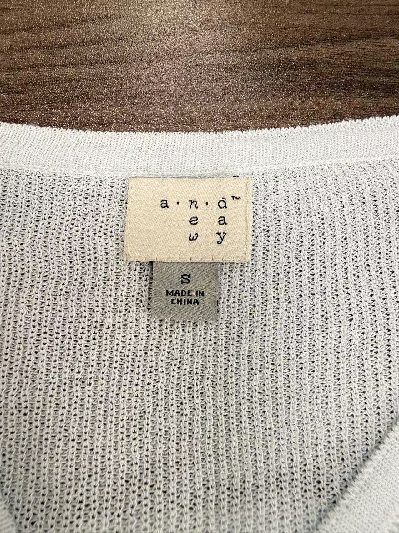 Close-up detail of v-neck collar and buttons on cardigan TF9267