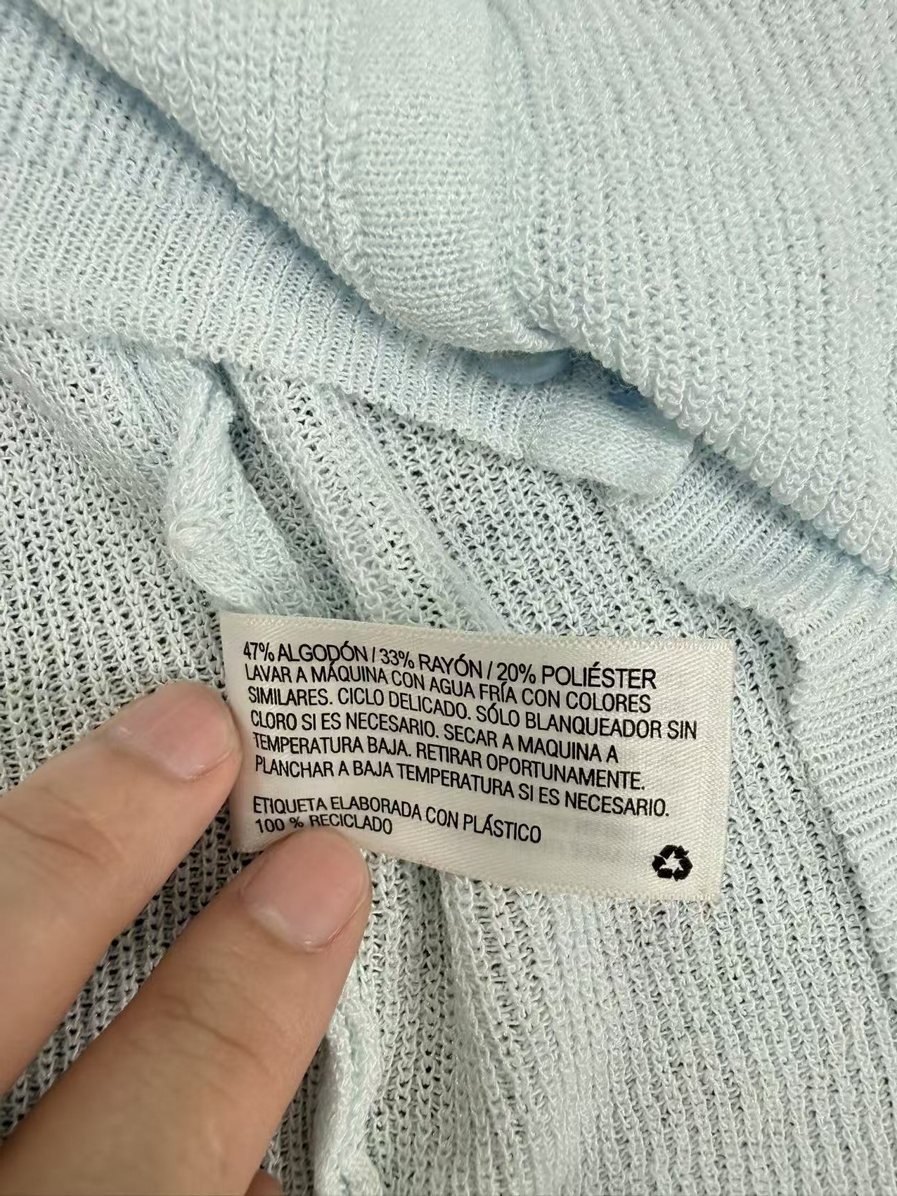 Label detail and soft knit fabric texture on women's cardigan