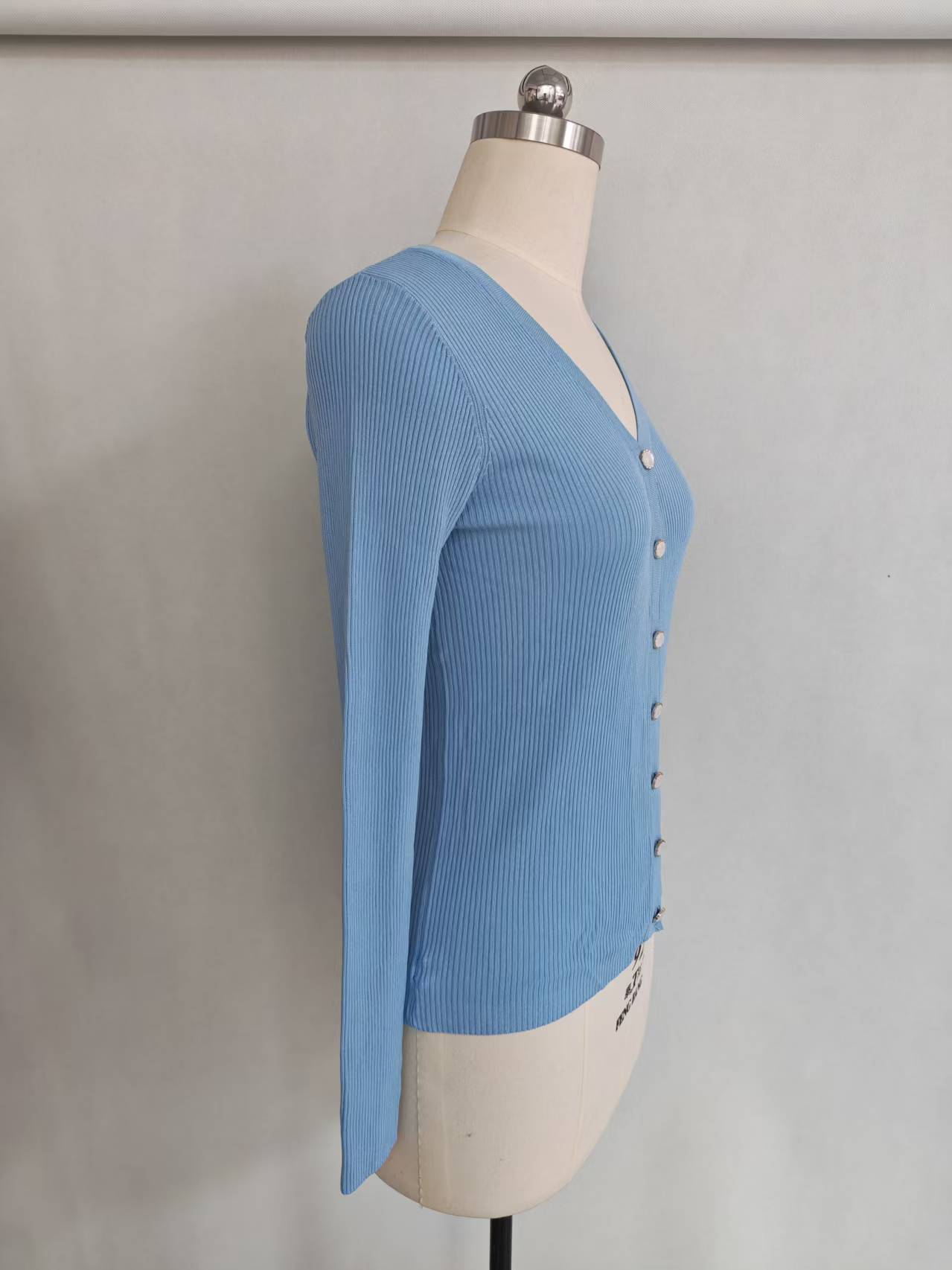 Front view of women's blue long sleeve button-up cardigan