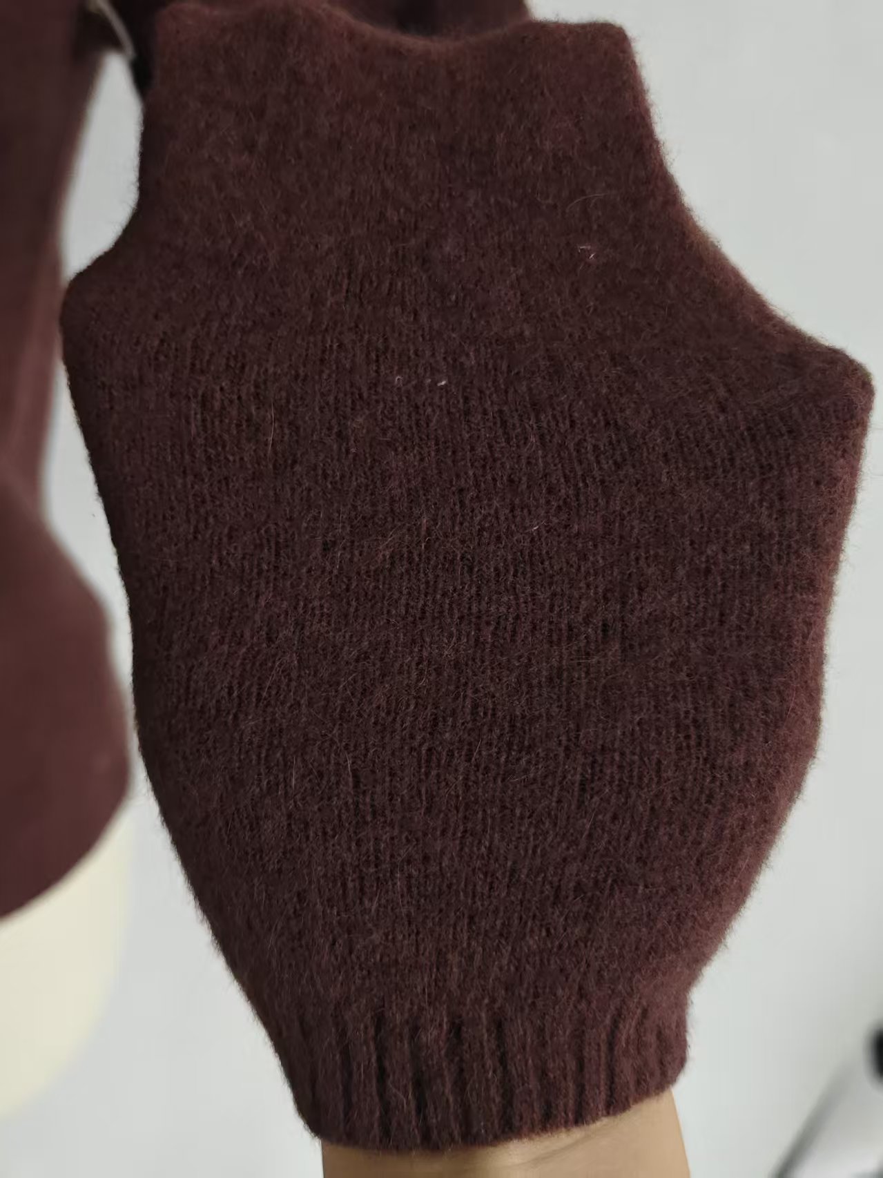 Close-up detail of v-neck collar and buttons on cardigan TF9498