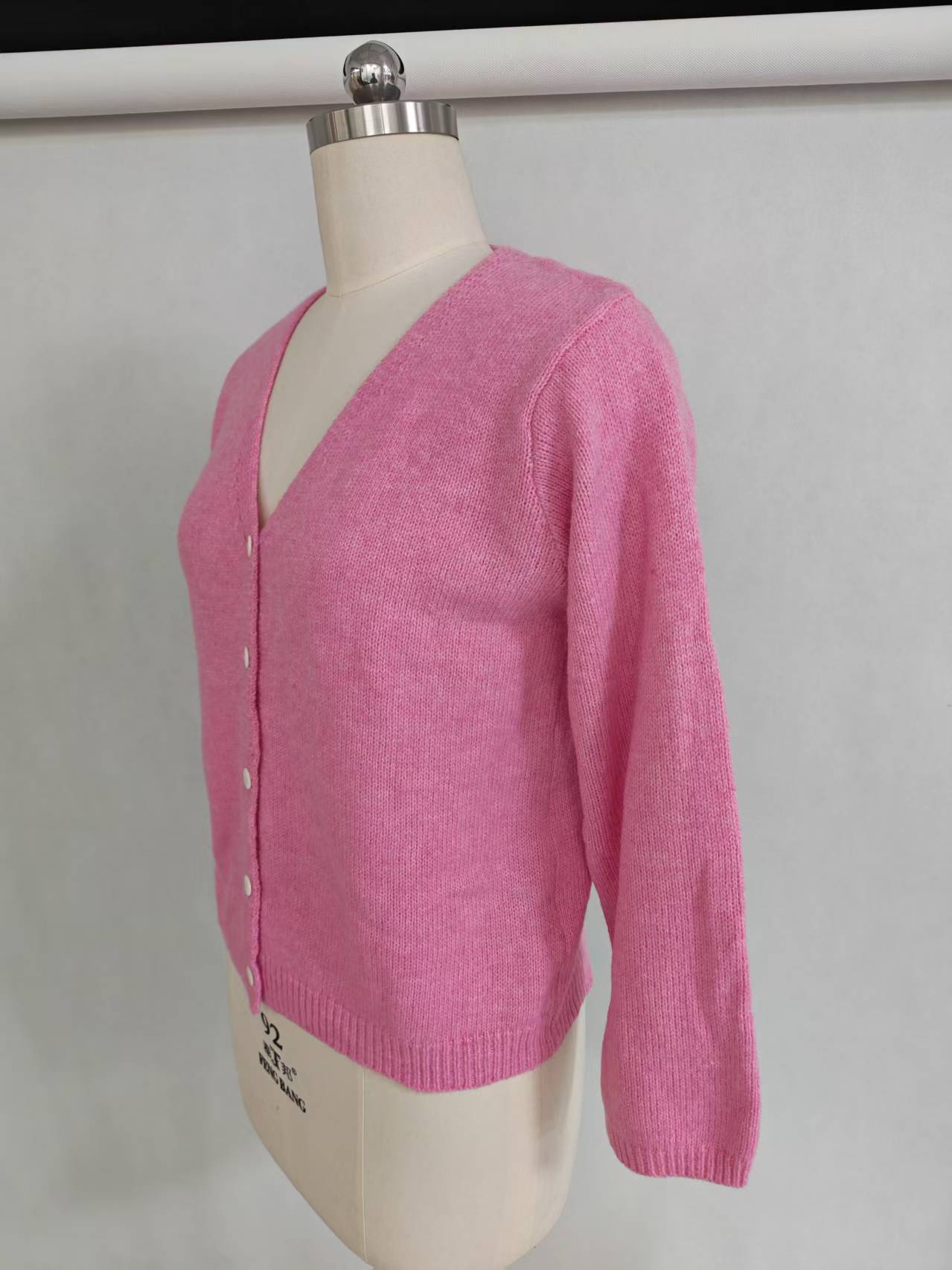 Front view of women's pink long sleeve button-up cardigan