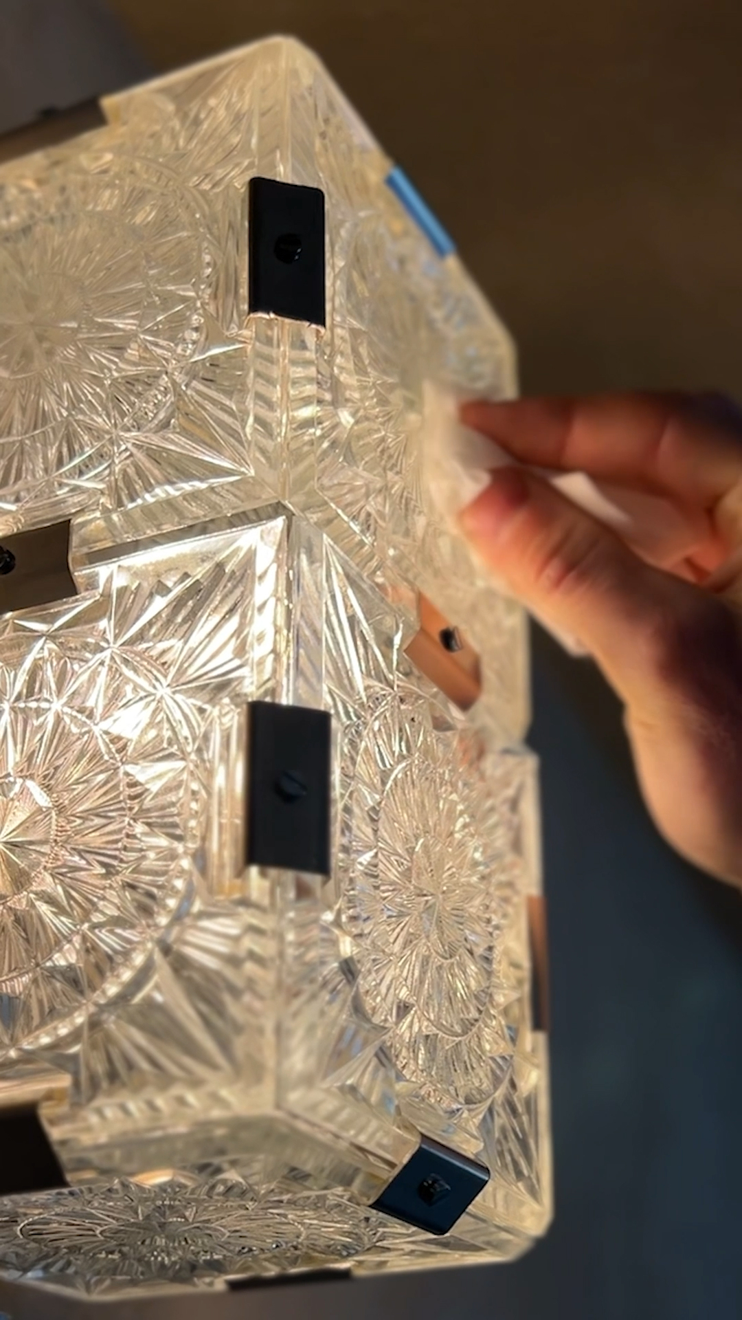 Detail of a crystal wall sconce light fixture being installed