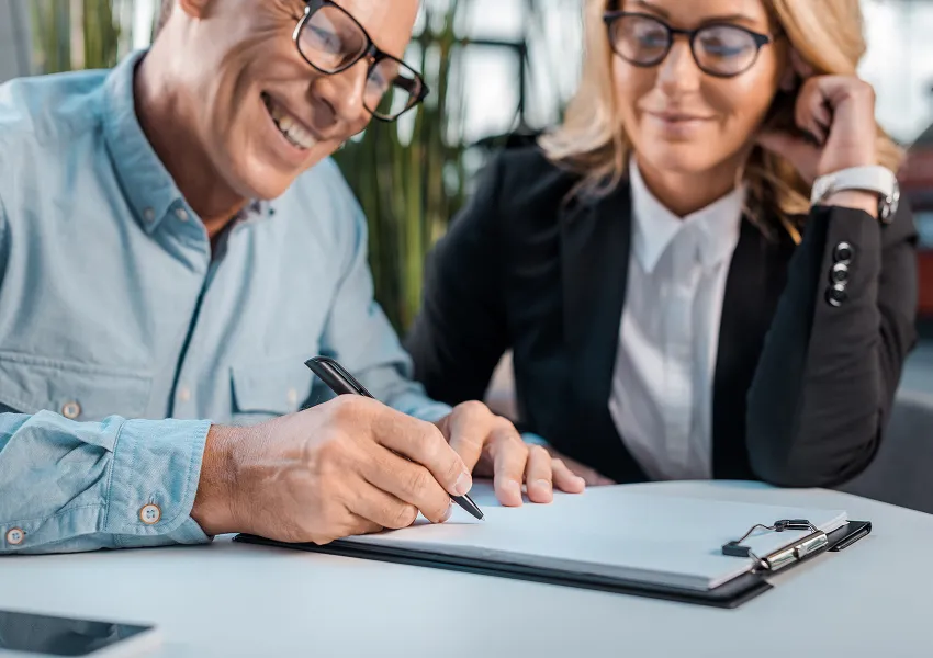 Insurance professionals reviewing documents together at a desk