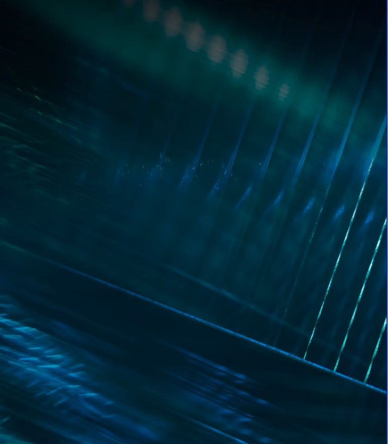 Abstract dark blue and green glowing streaks and lines creating a futuristic digital effect.