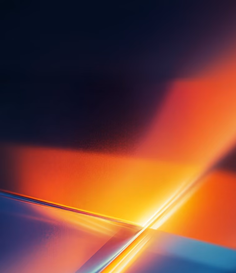 Abstract light beams crossing with blue and orange gradient glow on dark background.