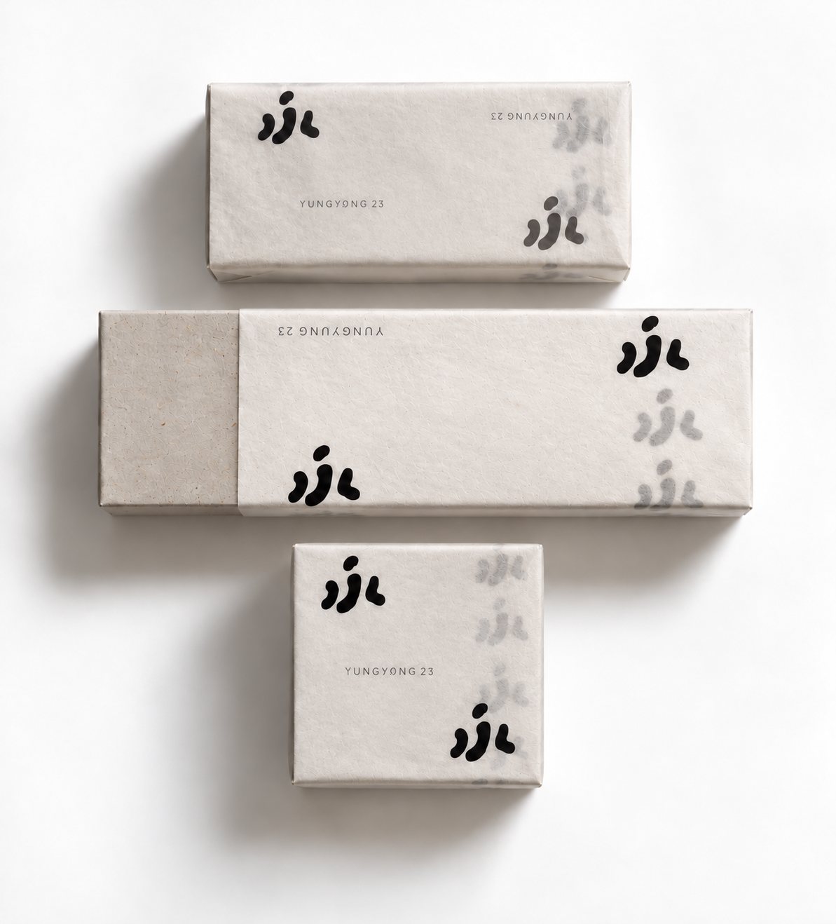Three Yung Yung tea boxes of different sizes wrapped in the same printed tissue