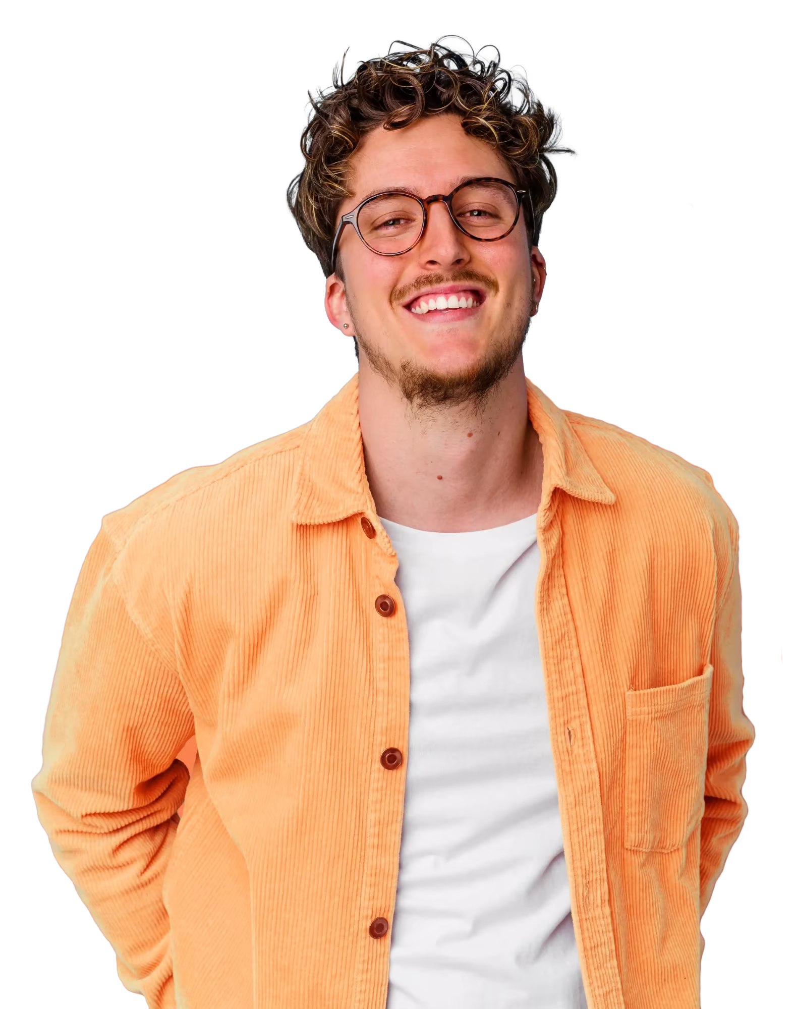 Un homme souriant portant des lunettes rondes, une chemise orange en velours côtelé et un t-shirt blanc.
