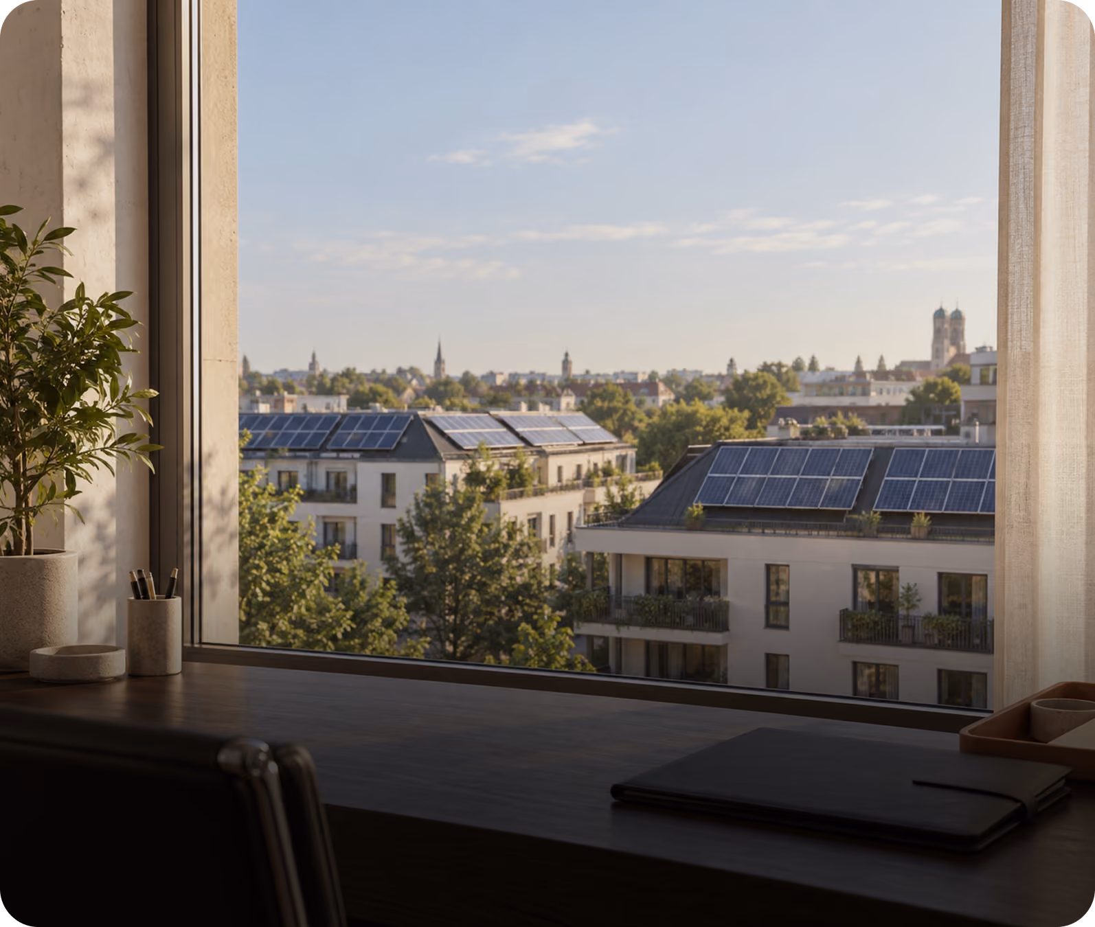 Blick aus dem Büro auf Mehrfamilienhäuser mit Photovoltaik-Dächern in der Stadt