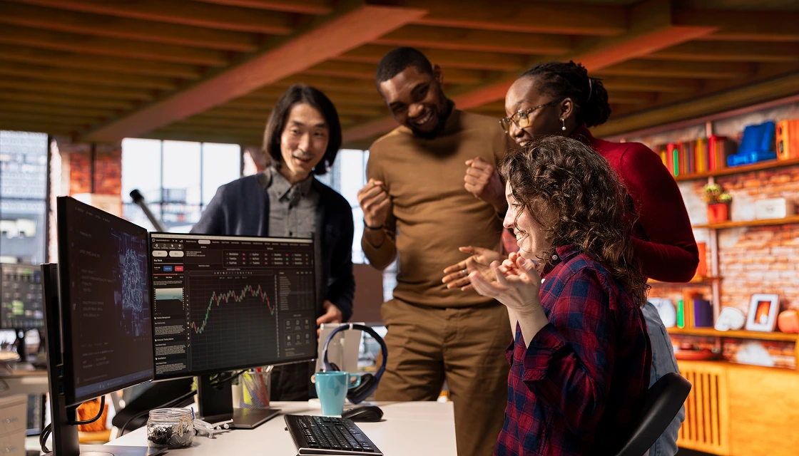 Enthusiastic Colleagues Celebrate Success in an Open Office