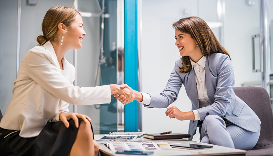 Women Shake Hands During a Meeting in Office
