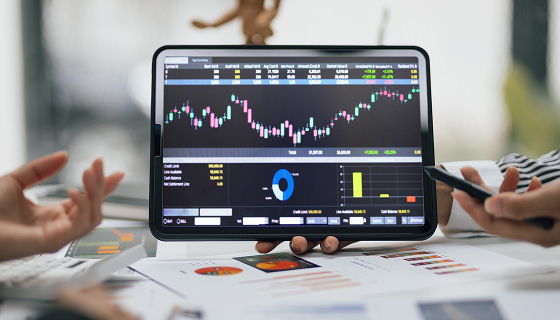 Team Analyzes Financial Data on a Tablet Device