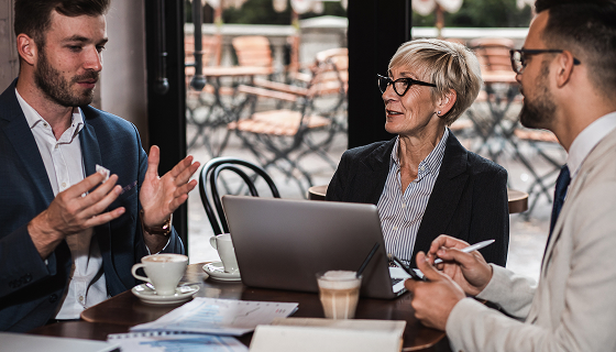 Business Professionals Meeting at Cafe Discussing Data