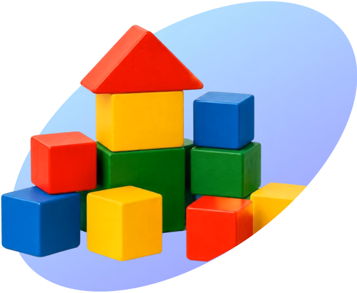 Colorful wooden blocks stacked to form a small house with a red triangular roof on a blue surface.