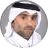 Portrait of a man wearing a white headscarf and traditional Middle Eastern attire.